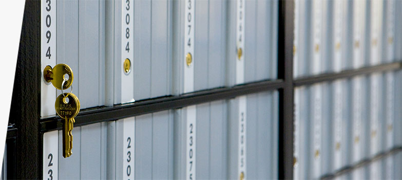 A set of keys hanging from a USPS PO Box.