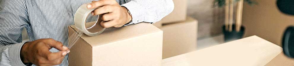Person taping a box shut.