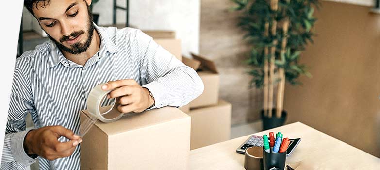 Person taping a box shut.